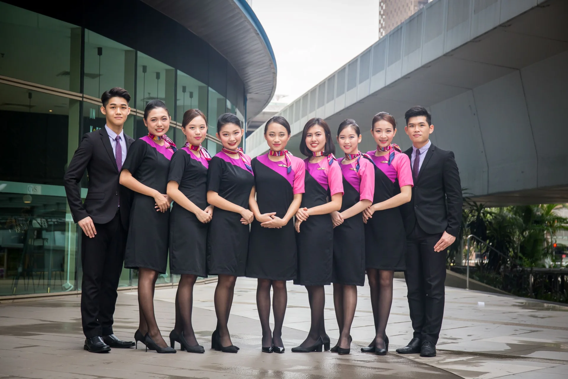 A group of cabin crew candidates in uniform posing together