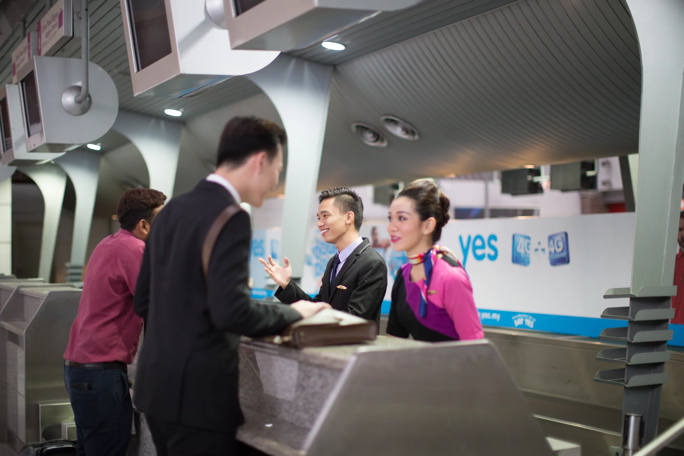 Students practising a passenger service role-play at a training counter