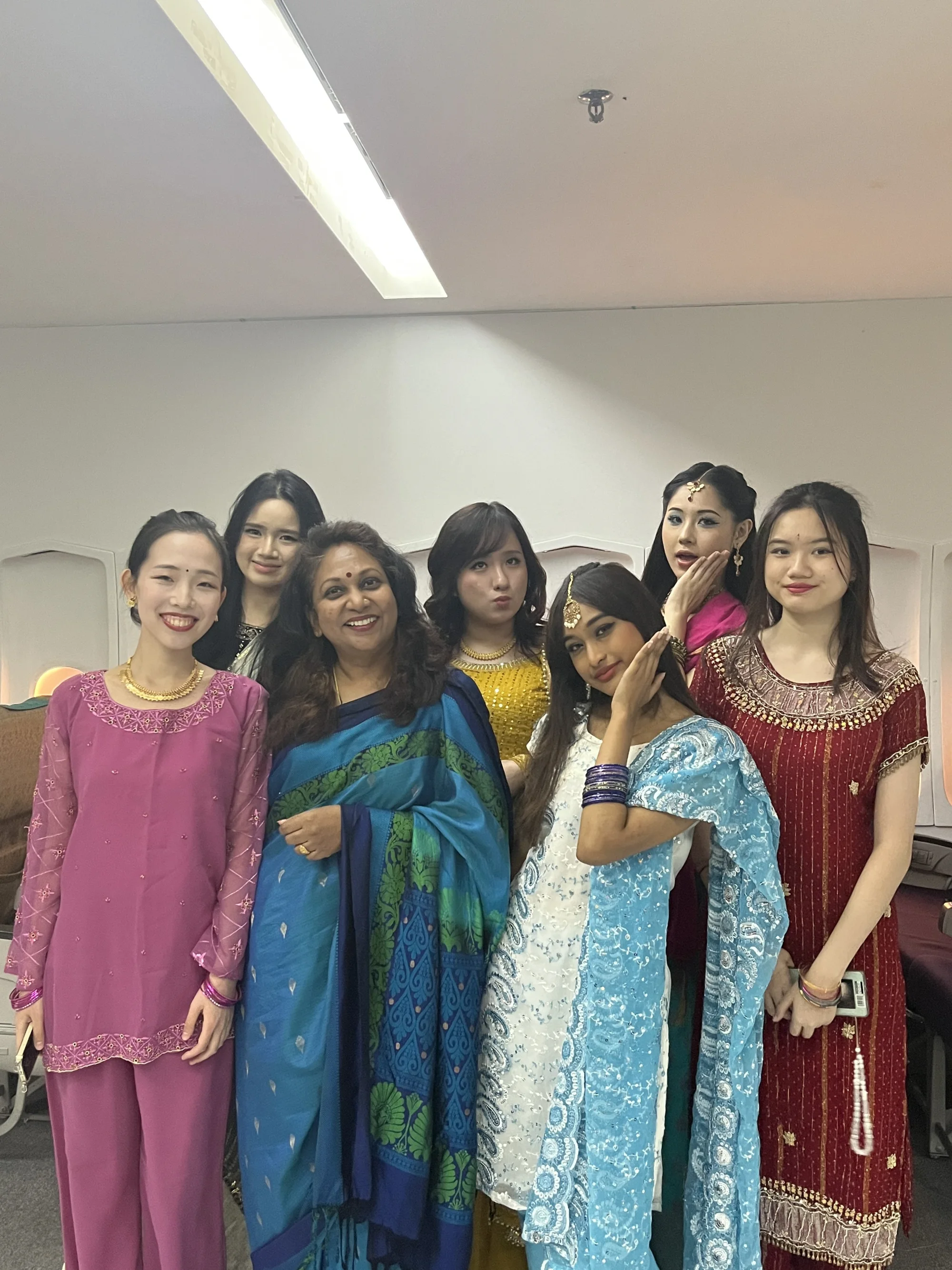 Students and a trainer in colourful traditional clothing