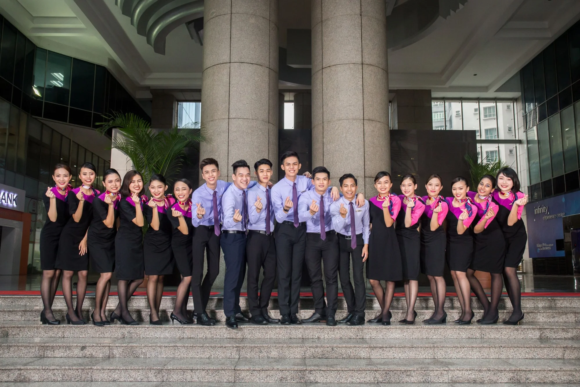IETA students in uniform standing together outside a campus building