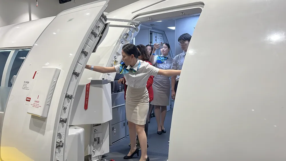 Students waiting at an aircraft door during a training visit