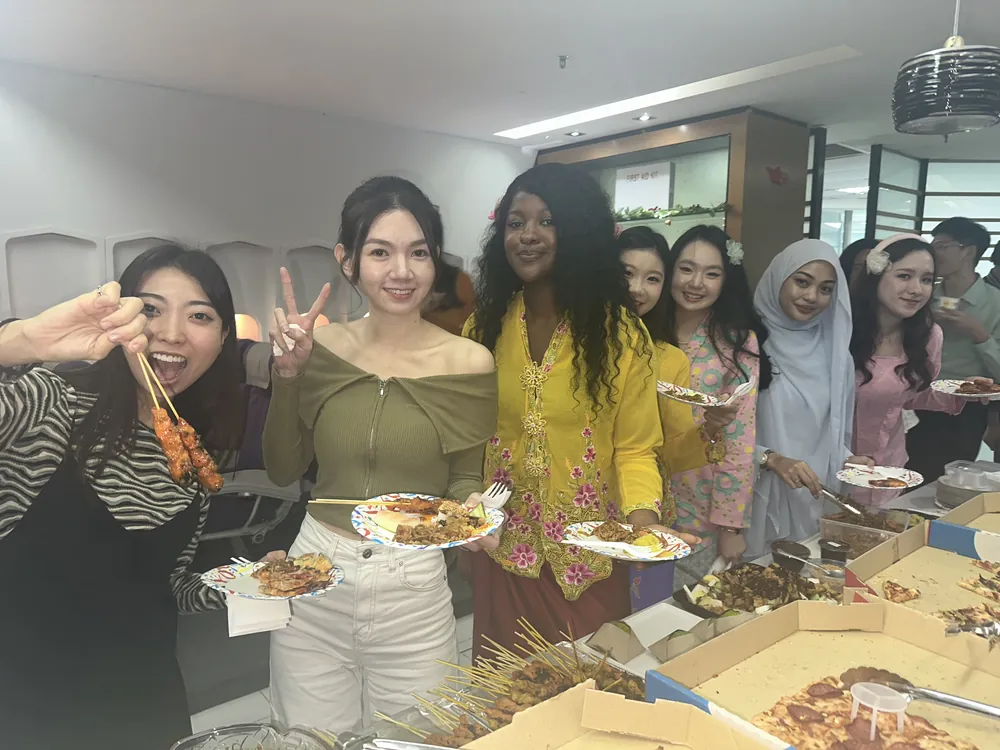 Students serving themselves from a buffet table at a gathering