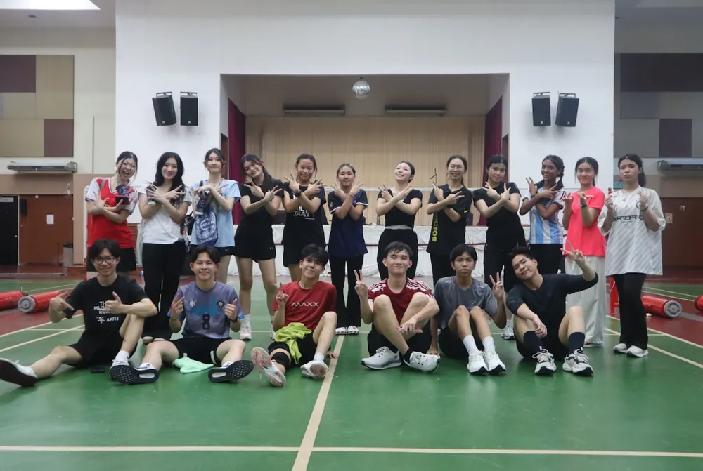 Students posing together in a sports hall