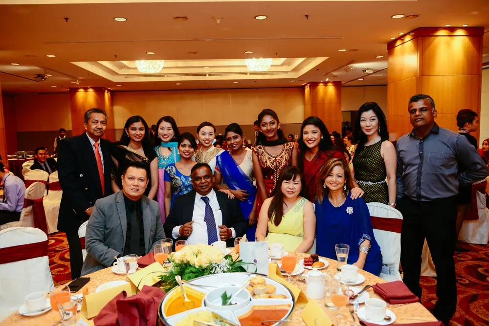 Graduates and guests gathered around a banquet table at the Inter Excel graduation dinner