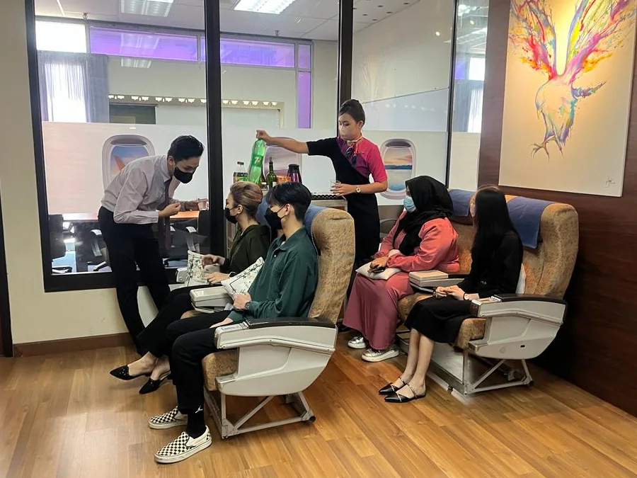 Visitors seated in the IETA mock aircraft cabin during a preview session